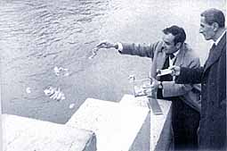 Yves Klein pouring gold into the river Seine, 1962